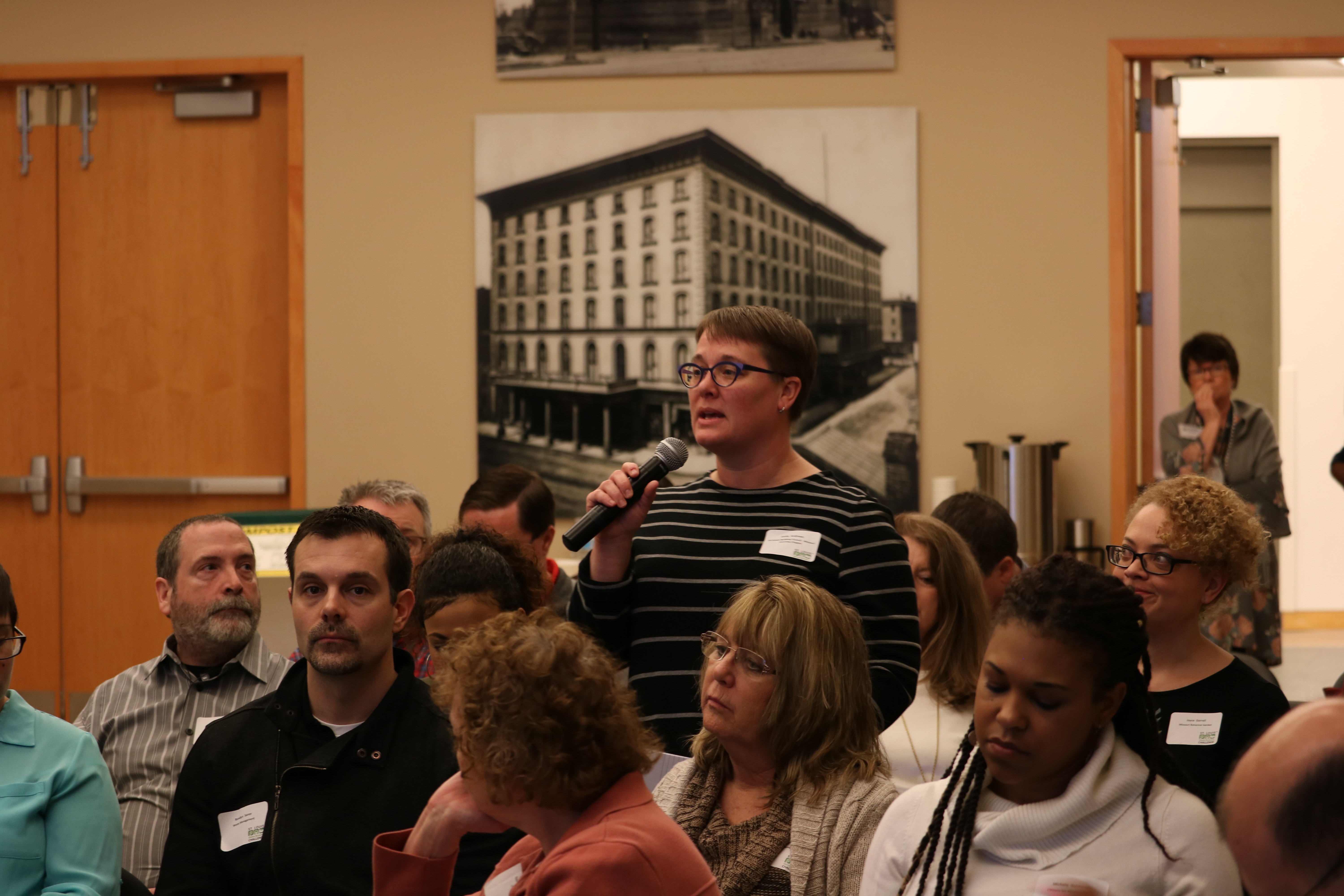 woman stands to ask question